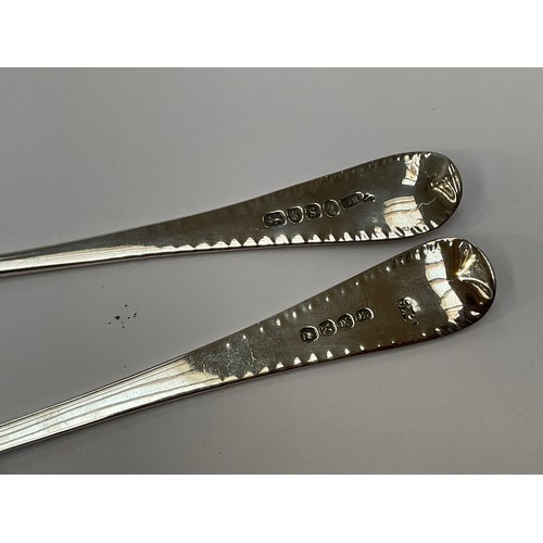 5066 - Two similar London assayed Georgian serving spoons with shell form bowls and bright cut handles, Tho... 