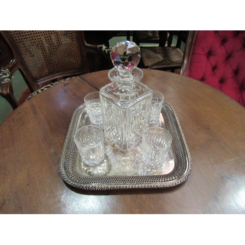 4068 - A crystal whisky decanter and four crystal glass tumblers on plated tray with pierced edge