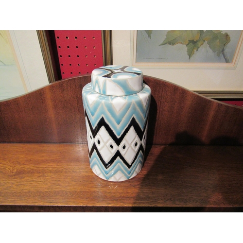 4082 - A lidded jar in powder blue, white and dark blue glaze, 19cm tall