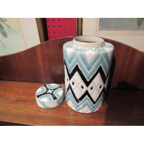 4082 - A lidded jar in powder blue, white and dark blue glaze, 19cm tall