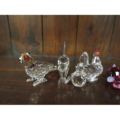 4120 - A collection of Swarovski crystal animals in original boxes: hen, set of four ducks, parrot with col... 