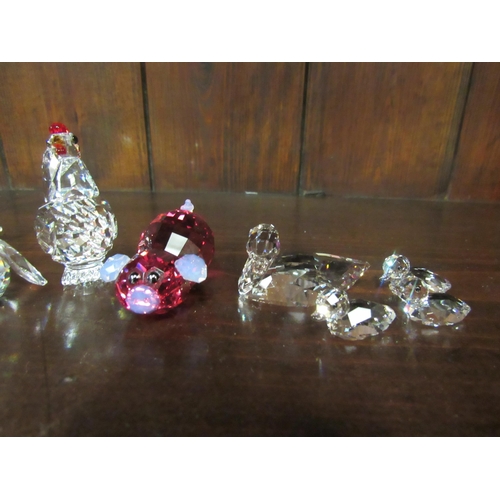 4120 - A collection of Swarovski crystal animals in original boxes: hen, set of four ducks, parrot with col... 