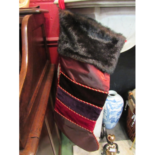 4144 - A pair of large Harrods Christmas stockings with faux fur trim and front pockets, 82cm high   (R) £2... 