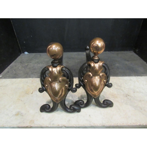 4146 - A pair of 19th Century style cast iron and copper fire dogs with orb finial and shield plaque front,... 