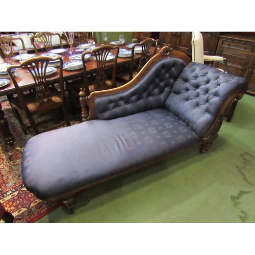 4156 - A Victorian walnut chaise longue, buttoned rich blue upholstery, on turned supports to castors, 96cm... 