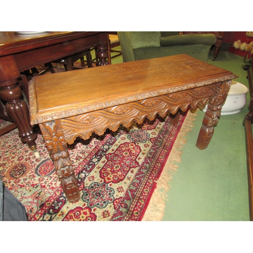 4164 - A carved oak hall table with shaped frieze, floral carved detailing, 55cm high x 104cm wide x 42cm d... 