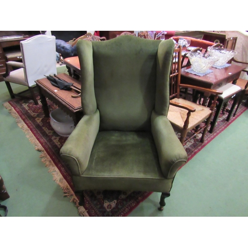 4166 - A 19th Century wing back fire side armchair the scroll arms over cabriole fore legs on ceramic casto... 