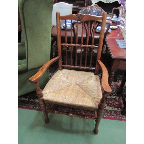 4167 - Circa 1800 revival a Northwest oak armchair, the carved top rail over a spindle backrest and sea gra... 