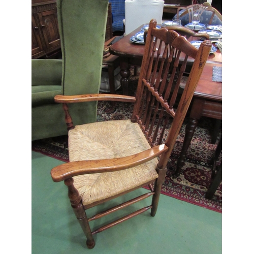 4167 - Circa 1800 revival a Northwest oak armchair, the carved top rail over a spindle backrest and sea gra... 