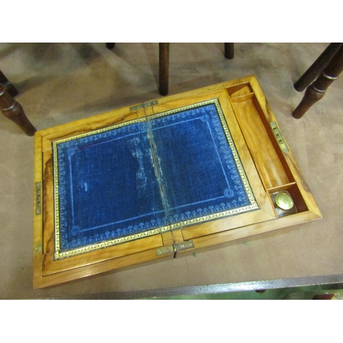 4197 - A walnut writing slope with mother-of-pearl inlay, some inlay missing, blue felt interior a/f