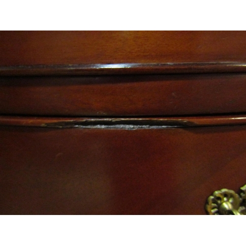 4211 - A Georgian style mahogany bow front chest, the sun ray veneered top over twelve drawers and carved l... 