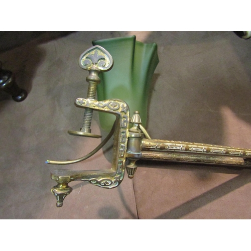 4212 - An ornate brass extending electric reading lamp with frosted green glass shade and table clamp   (R)... 