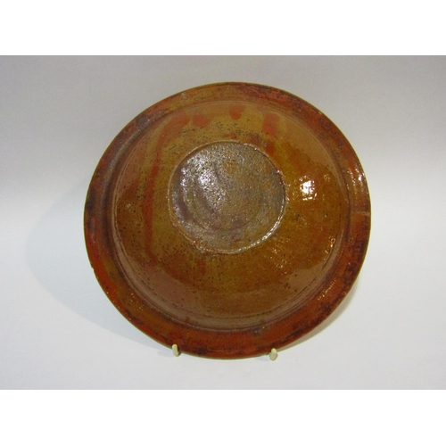 4258 - A slipware dish with crown and leaf decoration, 27cm diameter