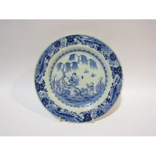 4260 - A finely decorated Chinese blue and white plate depicting a woman and boy carrying a fish, the rim d... 