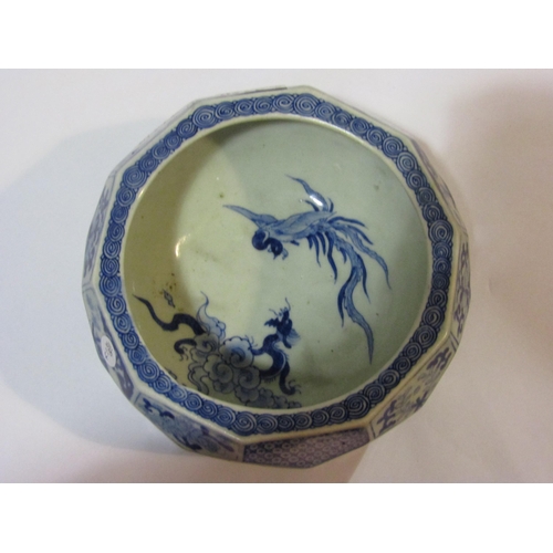 4270 - An Oriental blue and white bowl with facetted body, foliate design panels, scene of bird and dragon ... 