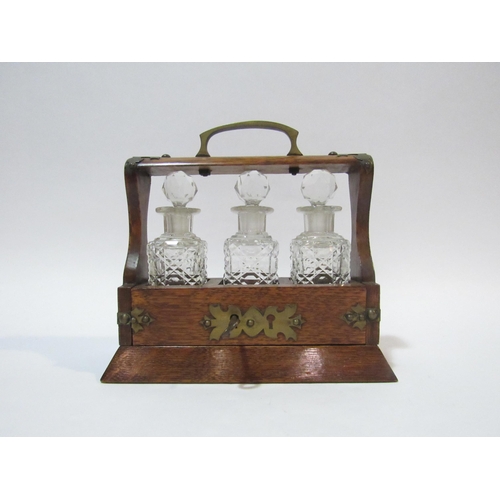 4103 - A Victorian apprentice miniature oak three bottle Tantalus with key   (R) £120