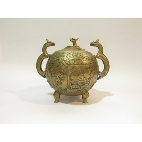 4284 - A 20th Century Oriental brass lidded censor of spherical form with two dragon shaped handles, on thr... 