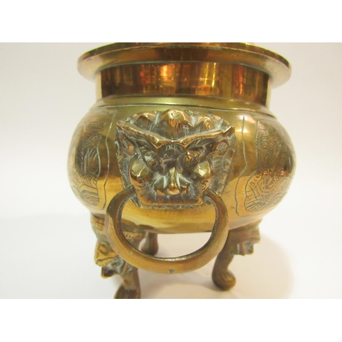 4285 - A Chinese brass censer with cover on tripod mask design feet, twin mask detail to body holding ring ... 