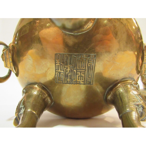 4285 - A Chinese brass censer with cover on tripod mask design feet, twin mask detail to body holding ring ... 