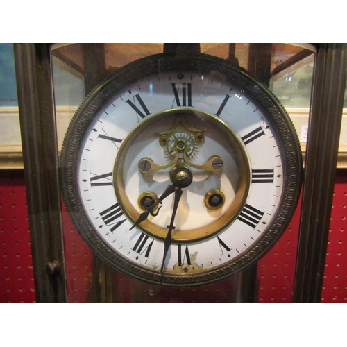 4044 - A four glass brass cased mantel clock, enamel dial with Roman numerals and key