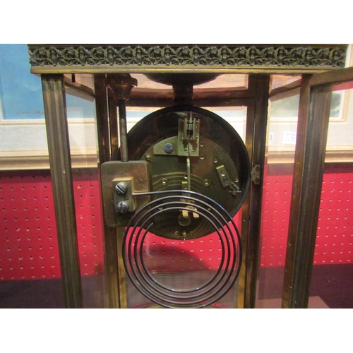 4044 - A four glass brass cased mantel clock, enamel dial with Roman numerals and key