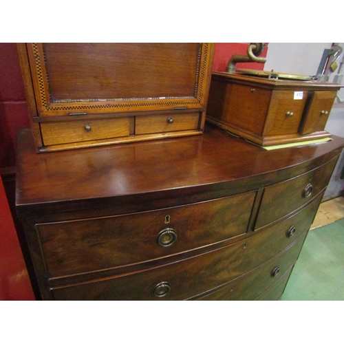 4153 - A George III flame mahogany bow front chest of two short over three graduating long drawers with oak... 