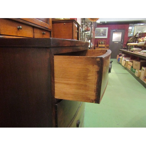 4153 - A George III flame mahogany bow front chest of two short over three graduating long drawers with oak... 