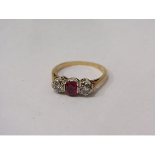 4389 - A ruby and diamond ring, the central oval ruby flanked by diamonds, stamped 18ct / plat, size K, 2.6... 