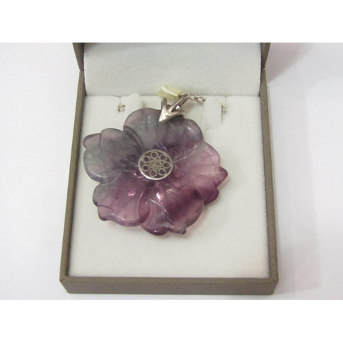 4396 - A natural flourite carved flower pendant with silver and amethyst cluster centre, on silver belcher ... 