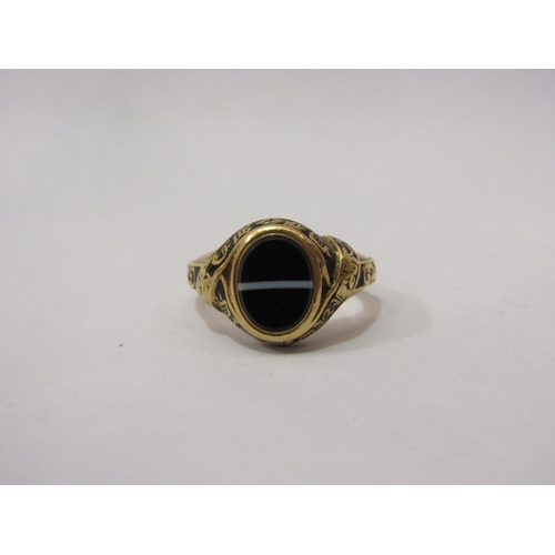 4417 - An 18ct gold memorium ring with oval banded, agate, black enamel decoration with inscription, 6g tot... 