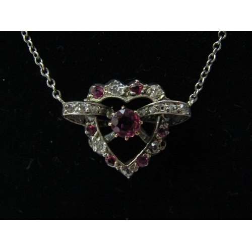 4425 - A diamond and ruby pendant as a heart on chain, unmarked