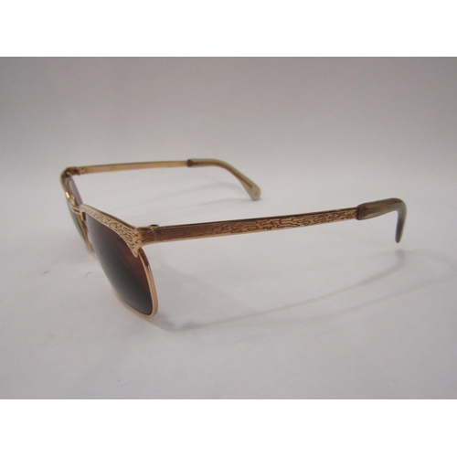 4444 - A pair of gold framed sunglasses stamped 14K