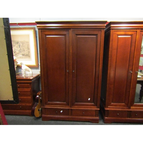 1043 - A Victorian style cherry wood wardrobe, two panelled doors, two drawer base, bracket feet, 196cm hig... 