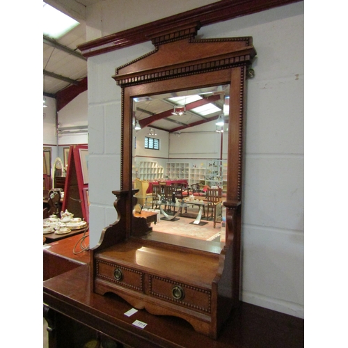 1063 - An oak hall mirror with bevel edged glass over two drawers, 93cm high x 49cm wide x 20cm deep   (R) ... 