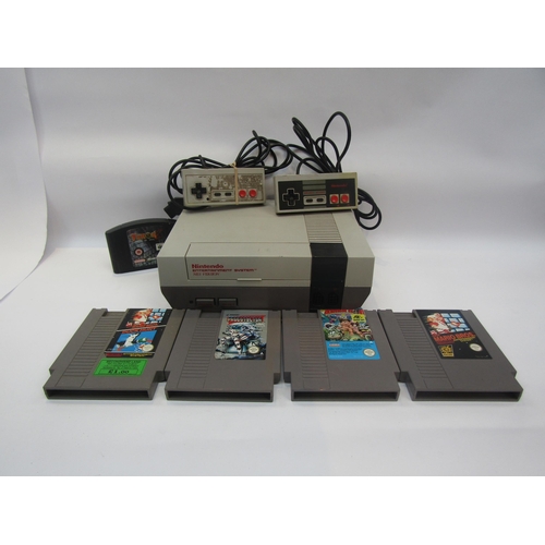 5027 - An unboxed Nintendo Entertainment System NES version computer games console with two controllers and... 