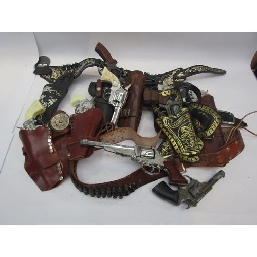 A collection of playworn toy guns, cap guns and pistols including Lone ...