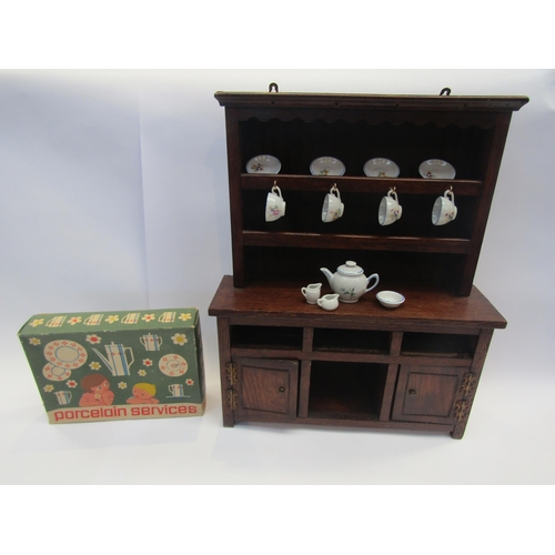 5117 - A miniature oak dresser and boxed dolls tea service