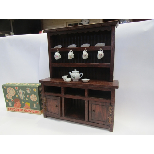 5117 - A miniature oak dresser and boxed dolls tea service