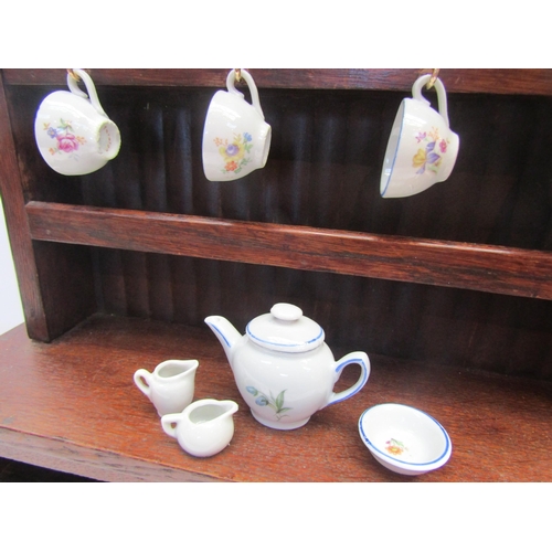 5117 - A miniature oak dresser and boxed dolls tea service