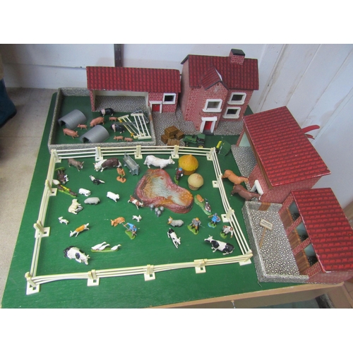 5120 - A wooden model farm with a collection of plastic figures and accessories including Britains