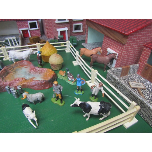 5120 - A wooden model farm with a collection of plastic figures and accessories including Britains