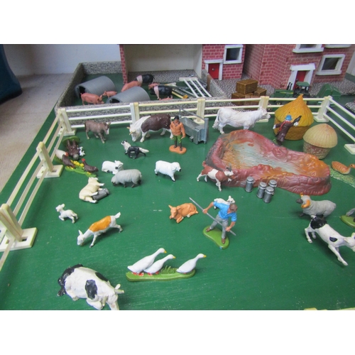 5120 - A wooden model farm with a collection of plastic figures and accessories including Britains