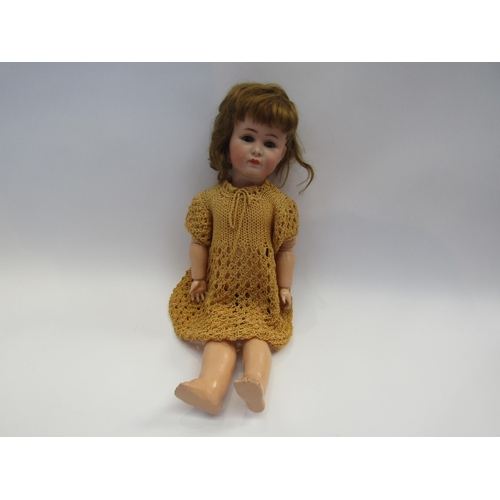 5130 - A Kammer & Reinhart 117A bisque head doll wih closed mouth, sleepy brown eyes and brown wig, jointed... 