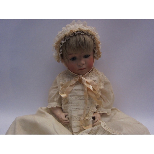 5131 - A German bisque head doll on jointed composition body, head heavily restored, 45cm tall