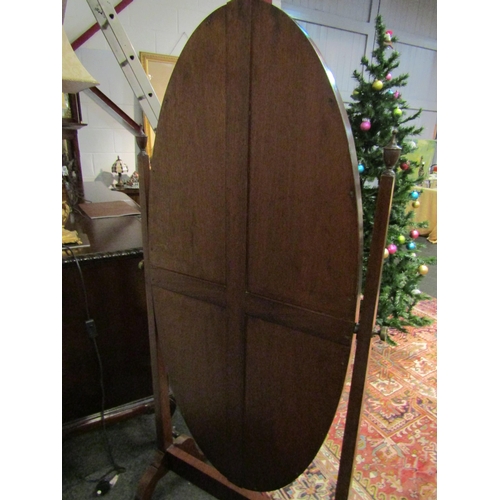 1015 - A mahogany cheval mirror with brass finial, on castors