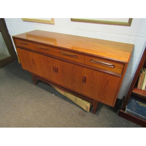 1033 - A G-Plan teak sideboard with four drawers over four door cupboard, 84cm high x 150cm wide x 45.5cm d... 