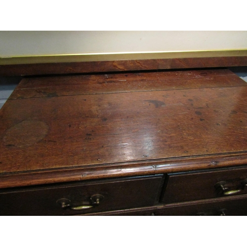 1047 - A George III oak straight front chest of two short over three long graduated drawers on bracket feet... 