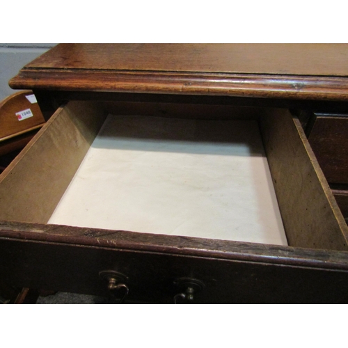 1047 - A George III oak straight front chest of two short over three long graduated drawers on bracket feet... 