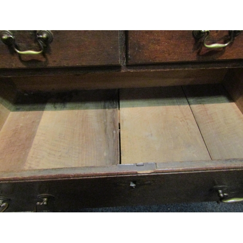 1047 - A George III oak straight front chest of two short over three long graduated drawers on bracket feet... 