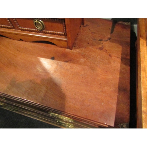 1064 - A George III mahogany straight front chest of four long graduated drawers with brushing slide.  Feet... 